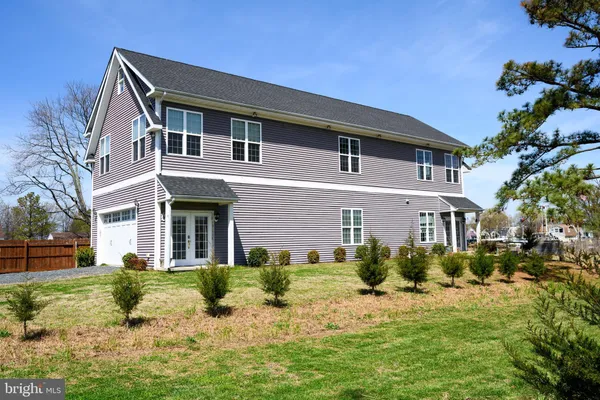 a dining hall with stainless steel appliances granite countertop a stove oven a dining table and chairs with wooden floor