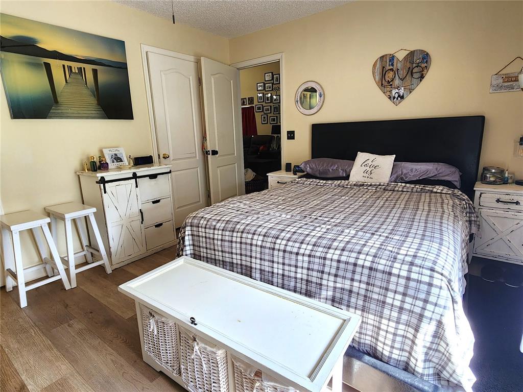 1701 Southeast 24th Road, Unit 1601 Ocala, FL 34471 - Photo 12 of 30 a bedroom with a bed a dresser and potted plant