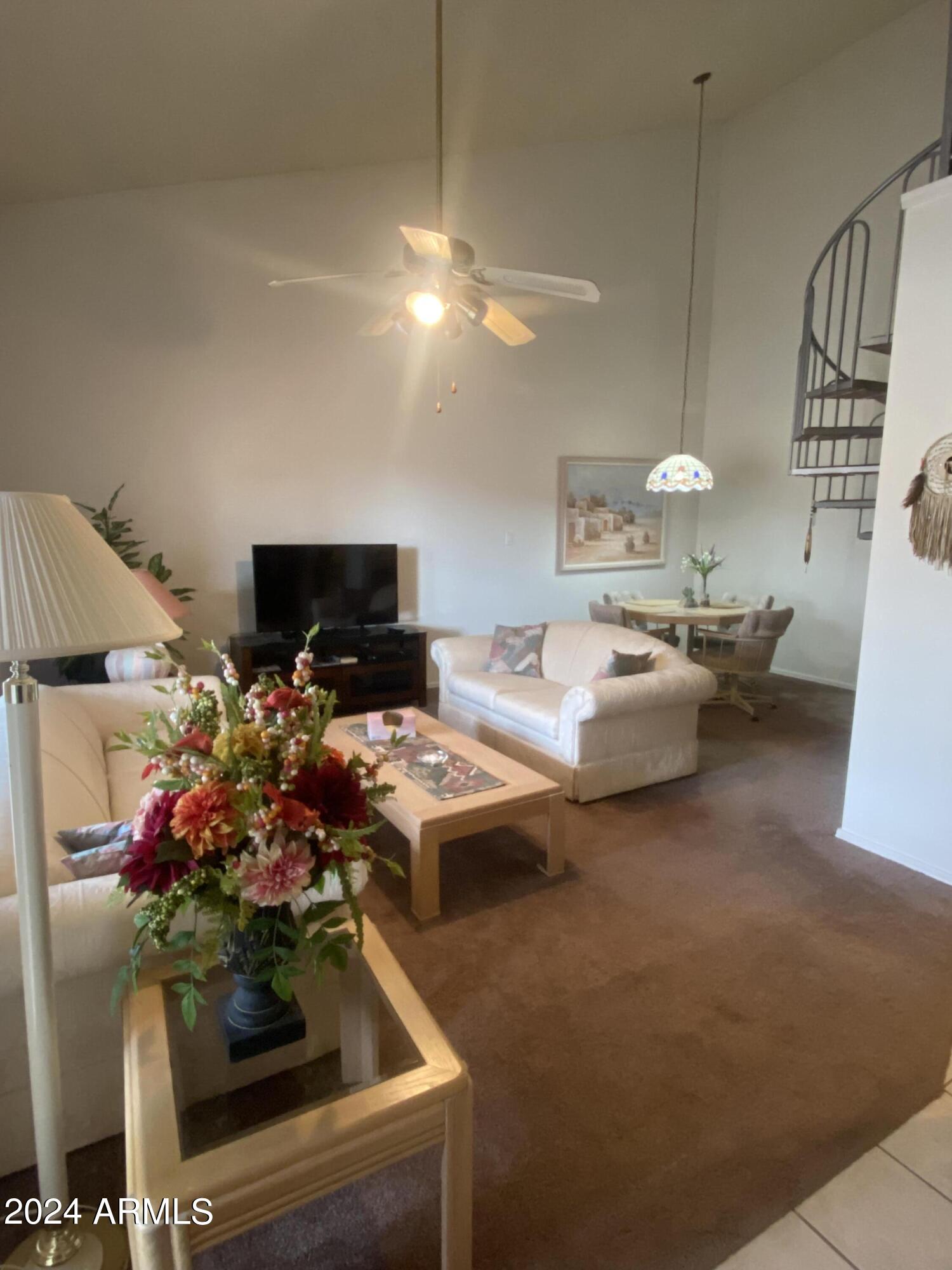 1440 North Idaho Road, Unit 1013 Apache Junction, AZ 85119 - Photo 15 of 40 a living room with furniture and a chandelier
