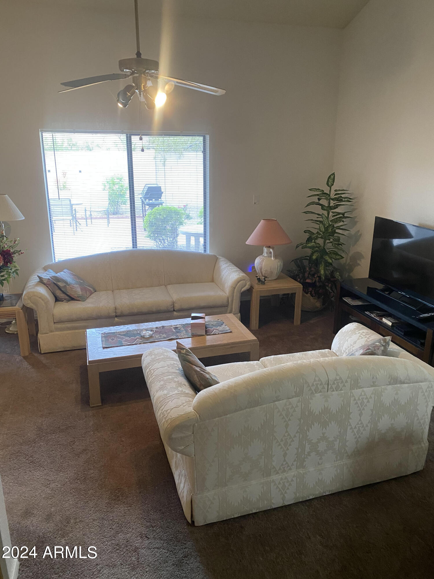 1440 North Idaho Road, Unit 1013 Apache Junction, AZ 85119 - Photo 17 of 40 a living room with furniture and a large window