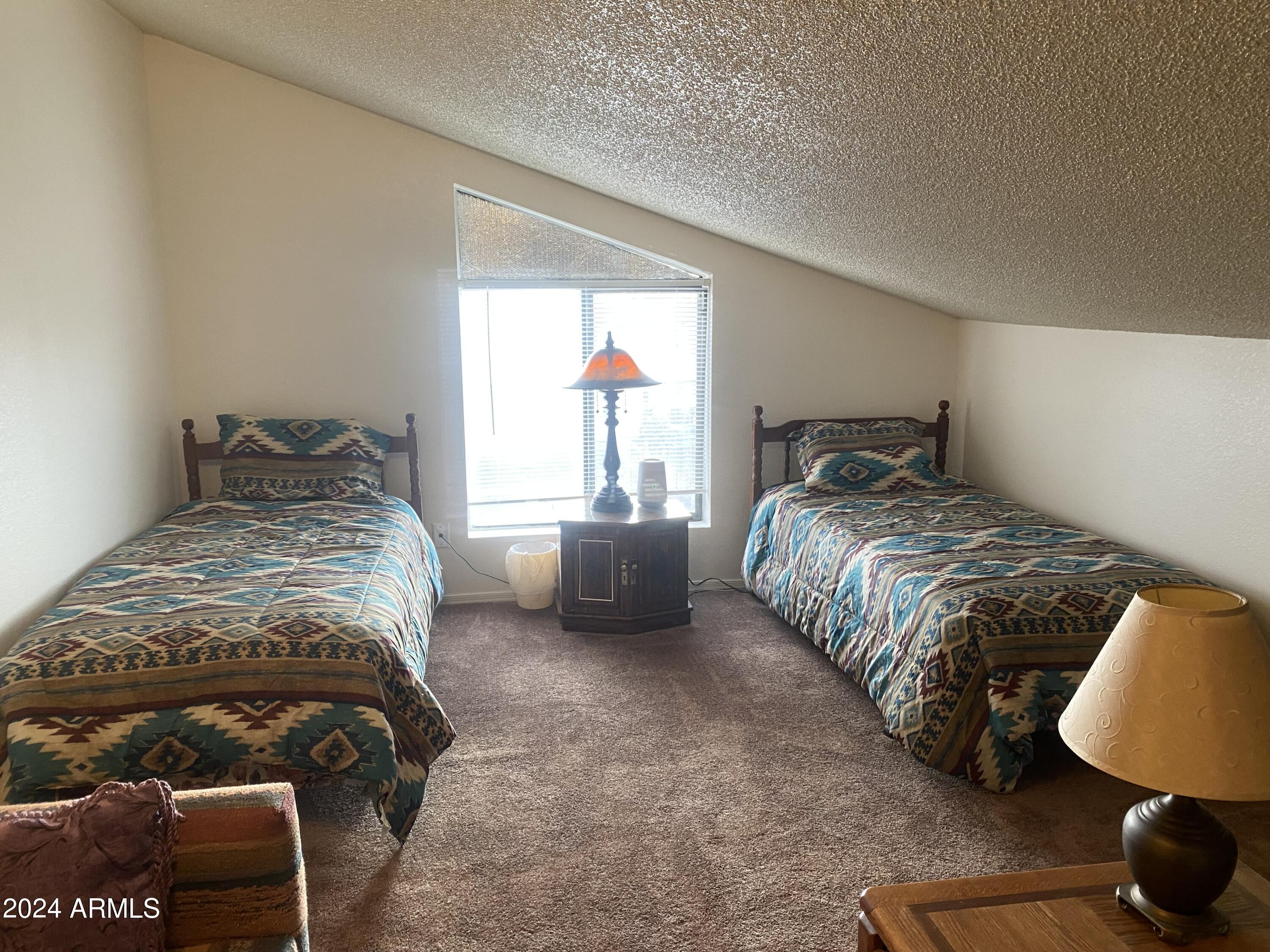 1440 North Idaho Road, Unit 1013 Apache Junction, AZ 85119 - Photo 29 of 40 a bedroom with a bed and a window