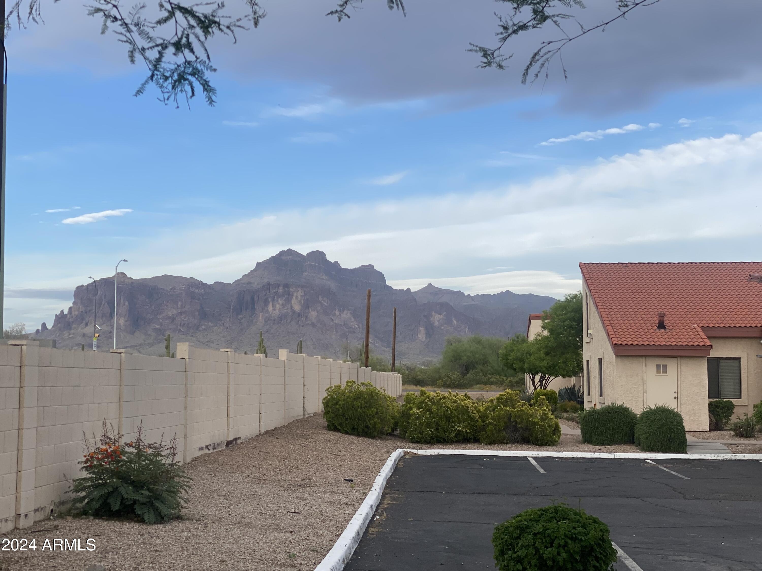 1440 North Idaho Road, Unit 1013 Apache Junction, AZ 85119 - Photo 4 of 40 a view of a street with a barn in the background
