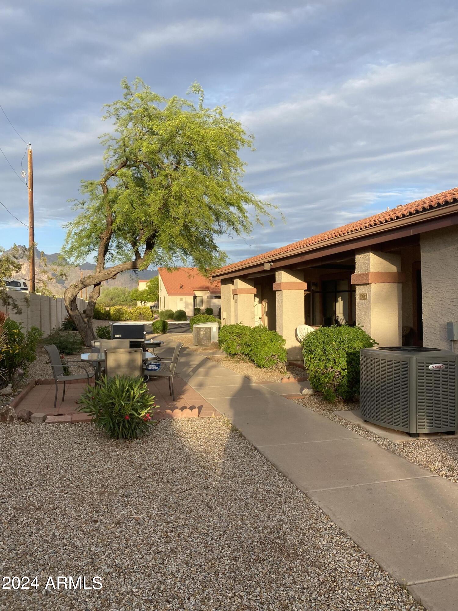 1440 North Idaho Road, Unit 1013 Apache Junction, AZ 85119 - Photo 5 of 40 a front view of a house with a yard