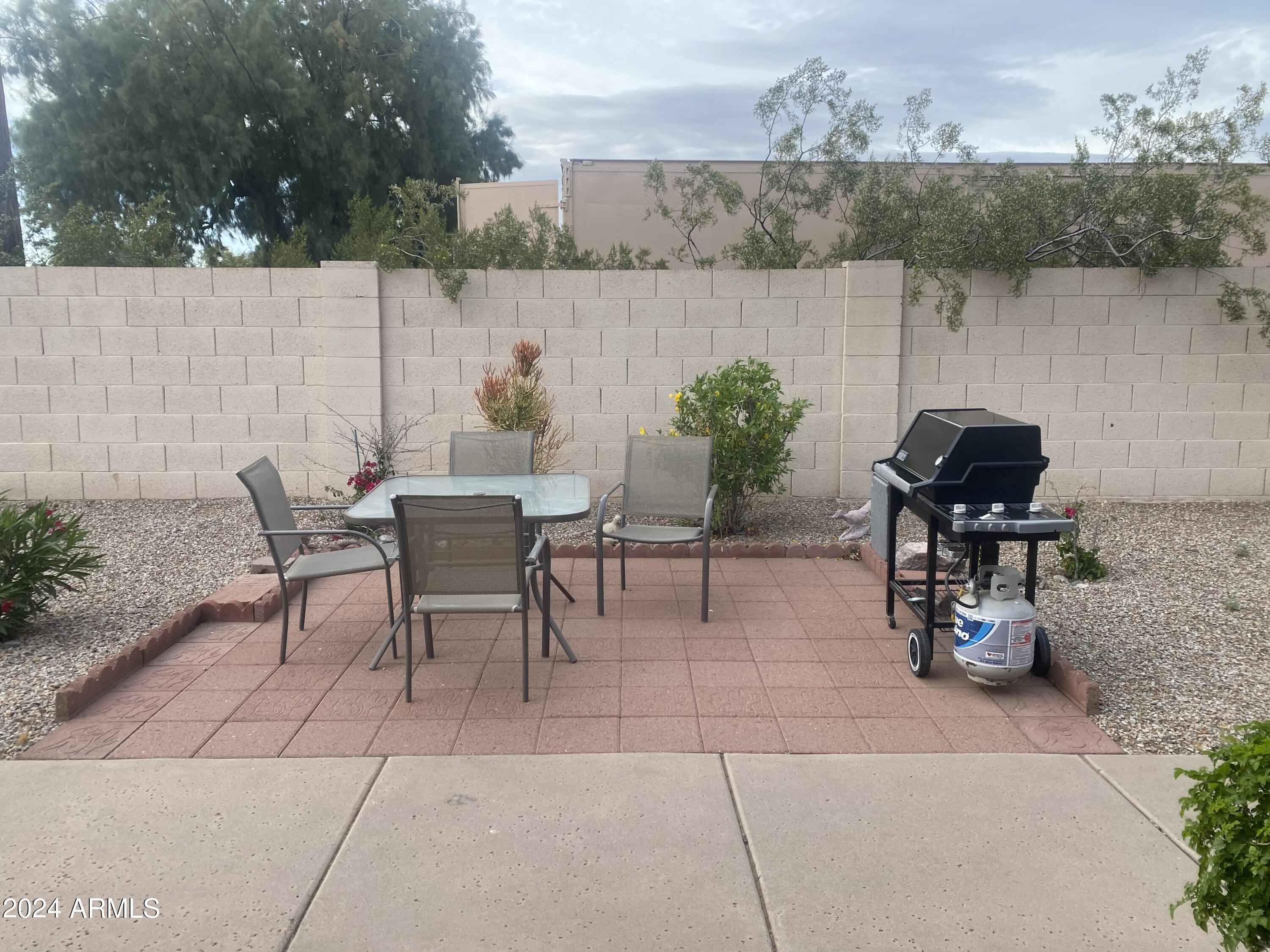 1440 North Idaho Road, Unit 1013 Apache Junction, AZ 85119 - Photo 7 of 40 a view of a chairs and table in patio