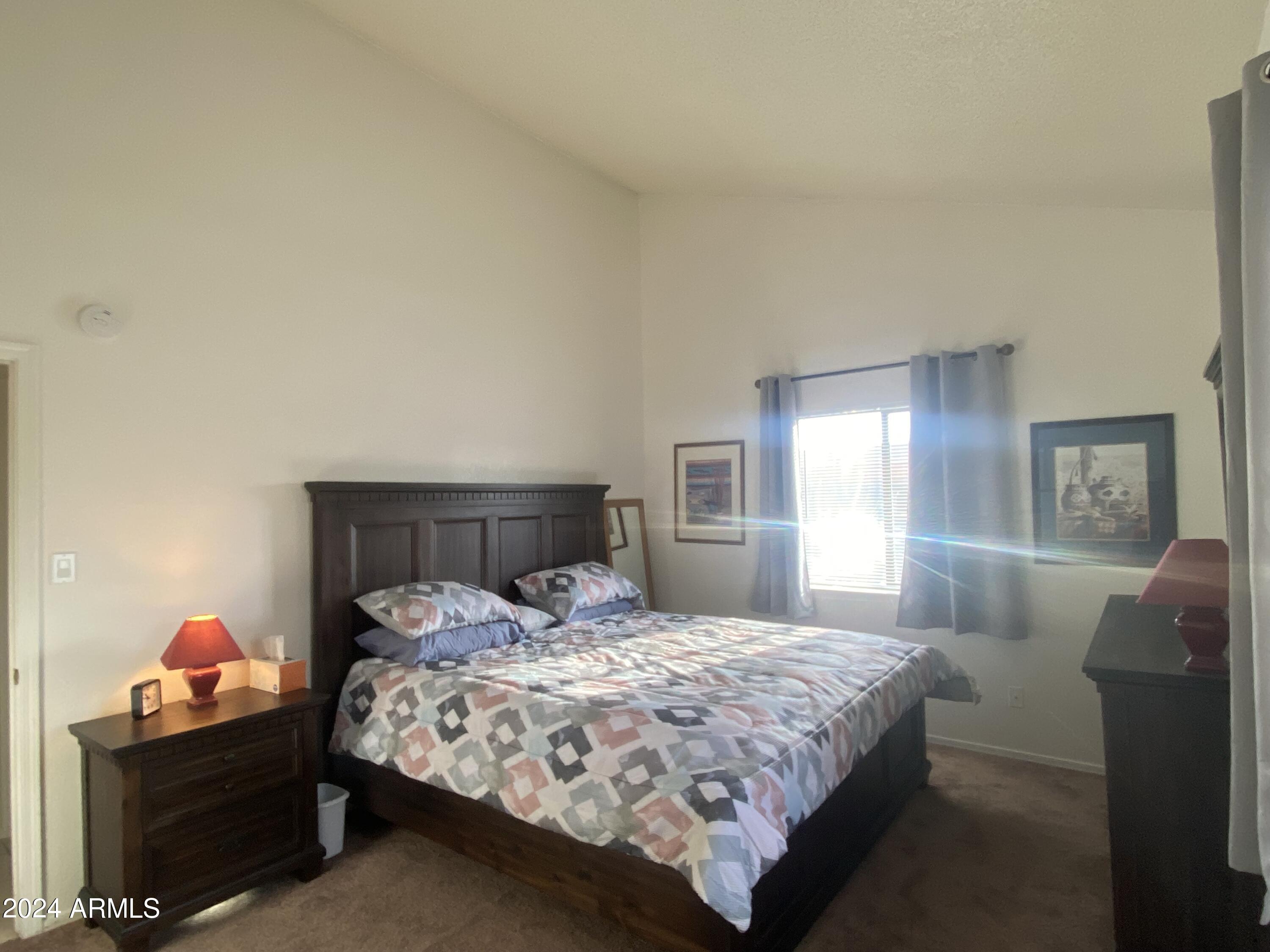 1440 North Idaho Road, Unit 1013 Apache Junction, AZ 85119 - Photo 8 of 40 a bedroom with a bed and window