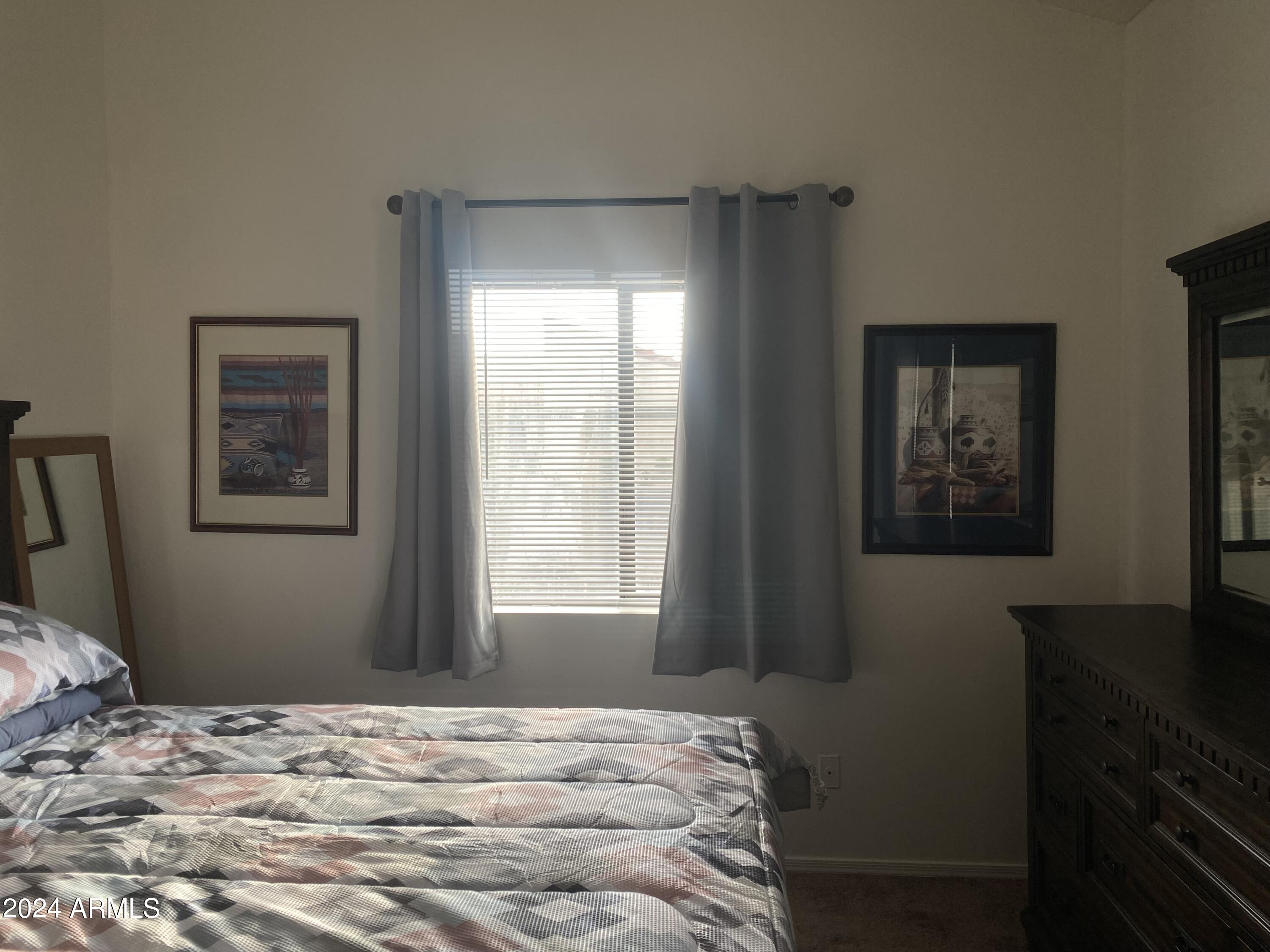 1440 North Idaho Road, Unit 1013 Apache Junction, AZ 85119 - Photo 9 of 40 a bedroom with a bed and wooden floor
