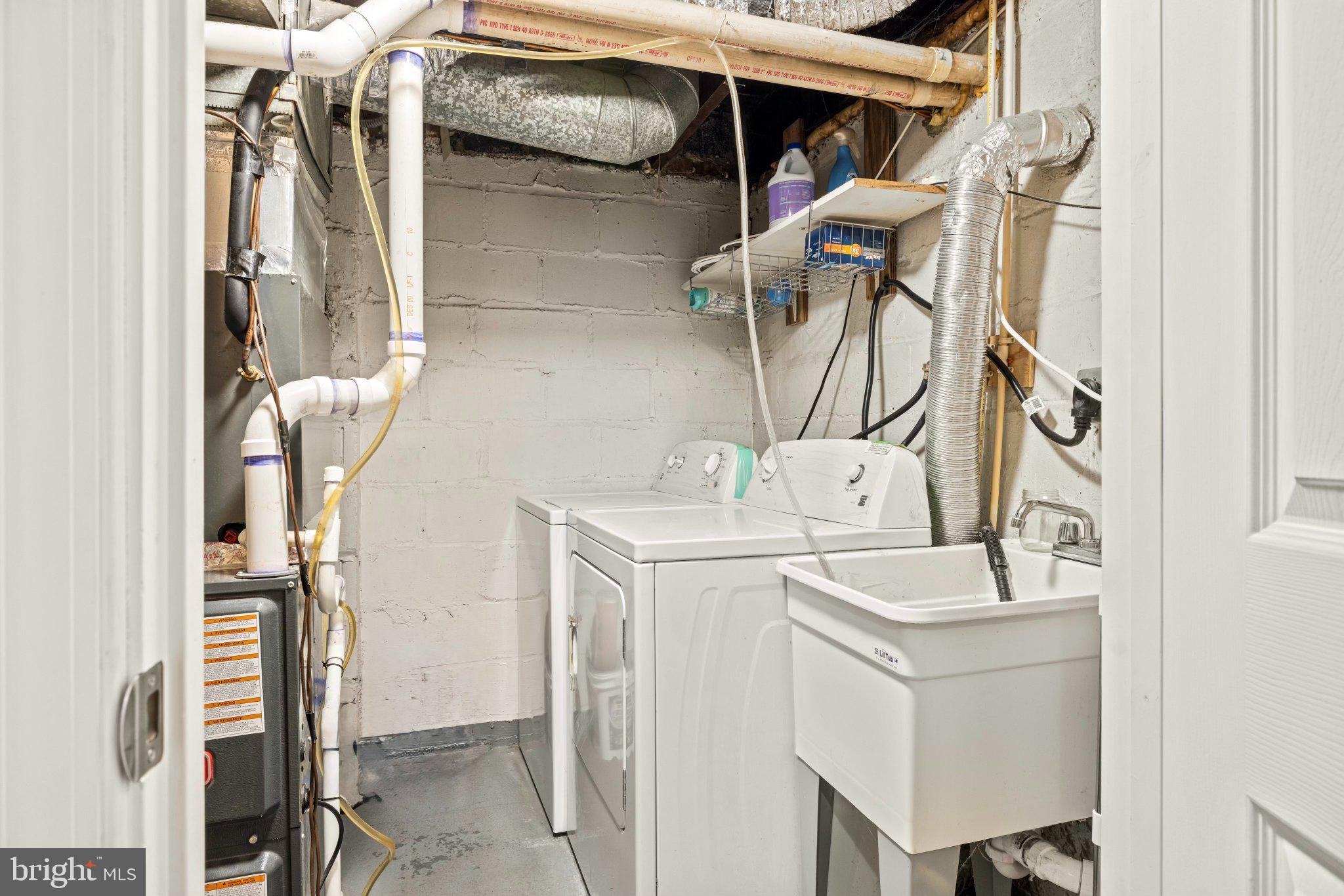 234 West Edgevale Road Baltimore, MD 21225 - Photo 21 of 45 Functional laundry space with utility sink.