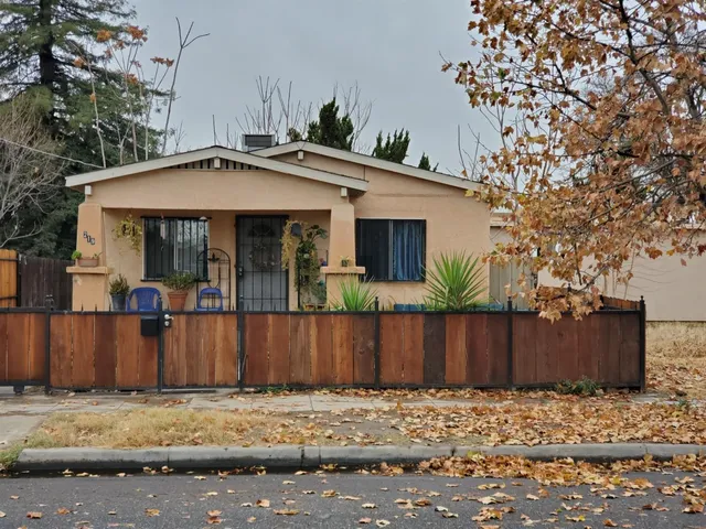 a view of a house with wooden fence
