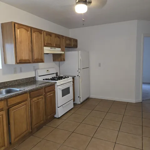 a kitchen with a stove a sink and a microwave