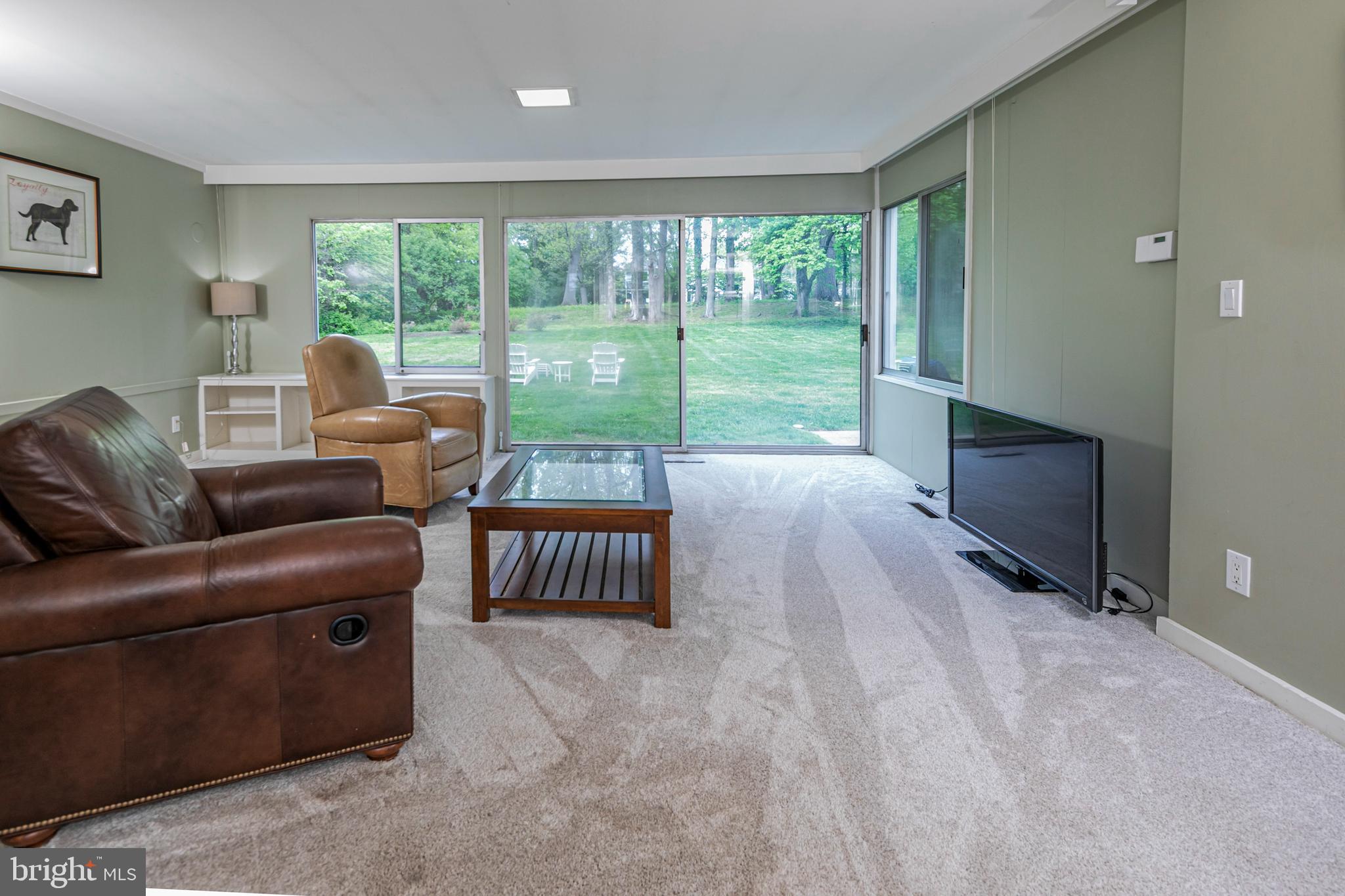 219 Russell Road Princeton, NJ 08540 - Photo 10 of 27 a living room with furniture and a floor to ceiling window