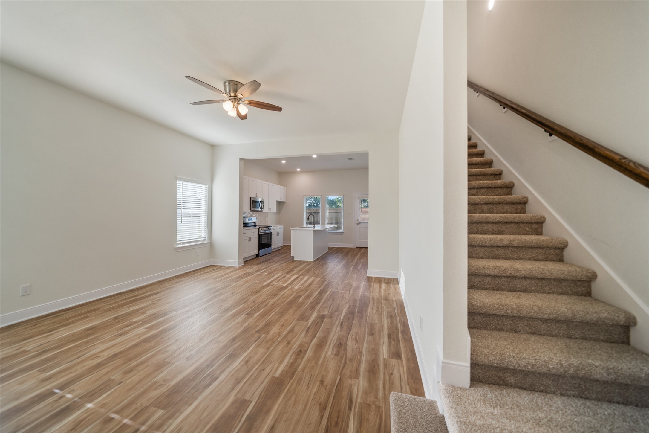 412 West Marlin Street Willis, TX 77378 - Photo 2 of 22 a view of a livingroom with wooden floor and a ceiling fan