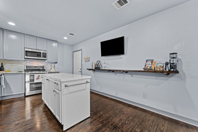 a kitchen with a sink and a stove top oven