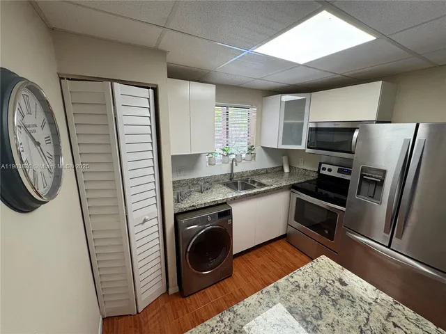 a kitchen with a stove and a refrigerator