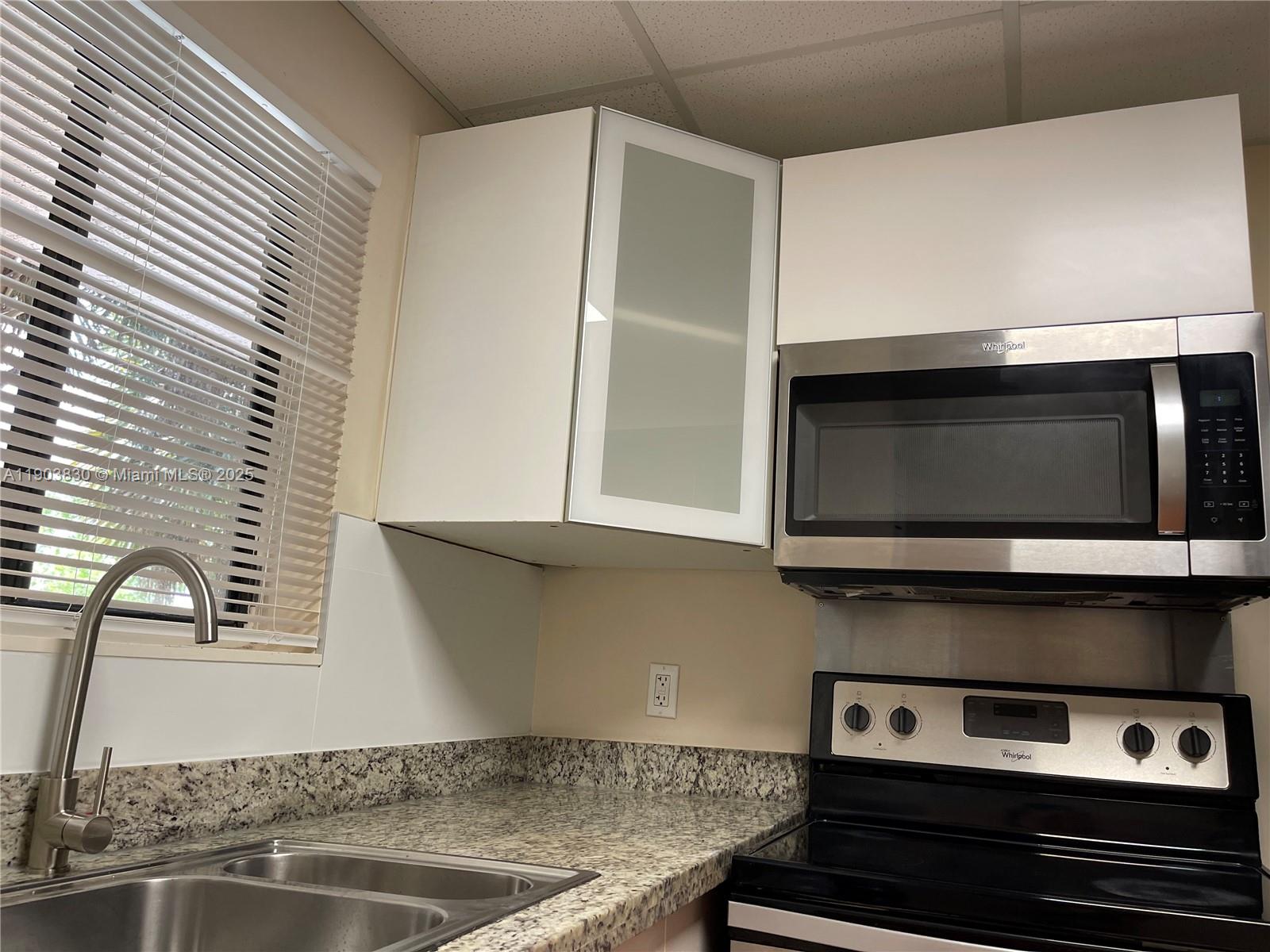 6900 Southwest 39th Street, Unit 206J Davie, FL 33314 - Photo 12 of 34 a kitchen with a stove and a microwave