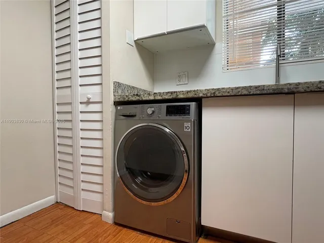 a kitchen with granite countertop stainless steel appliances a sink stove top oven and cabinets