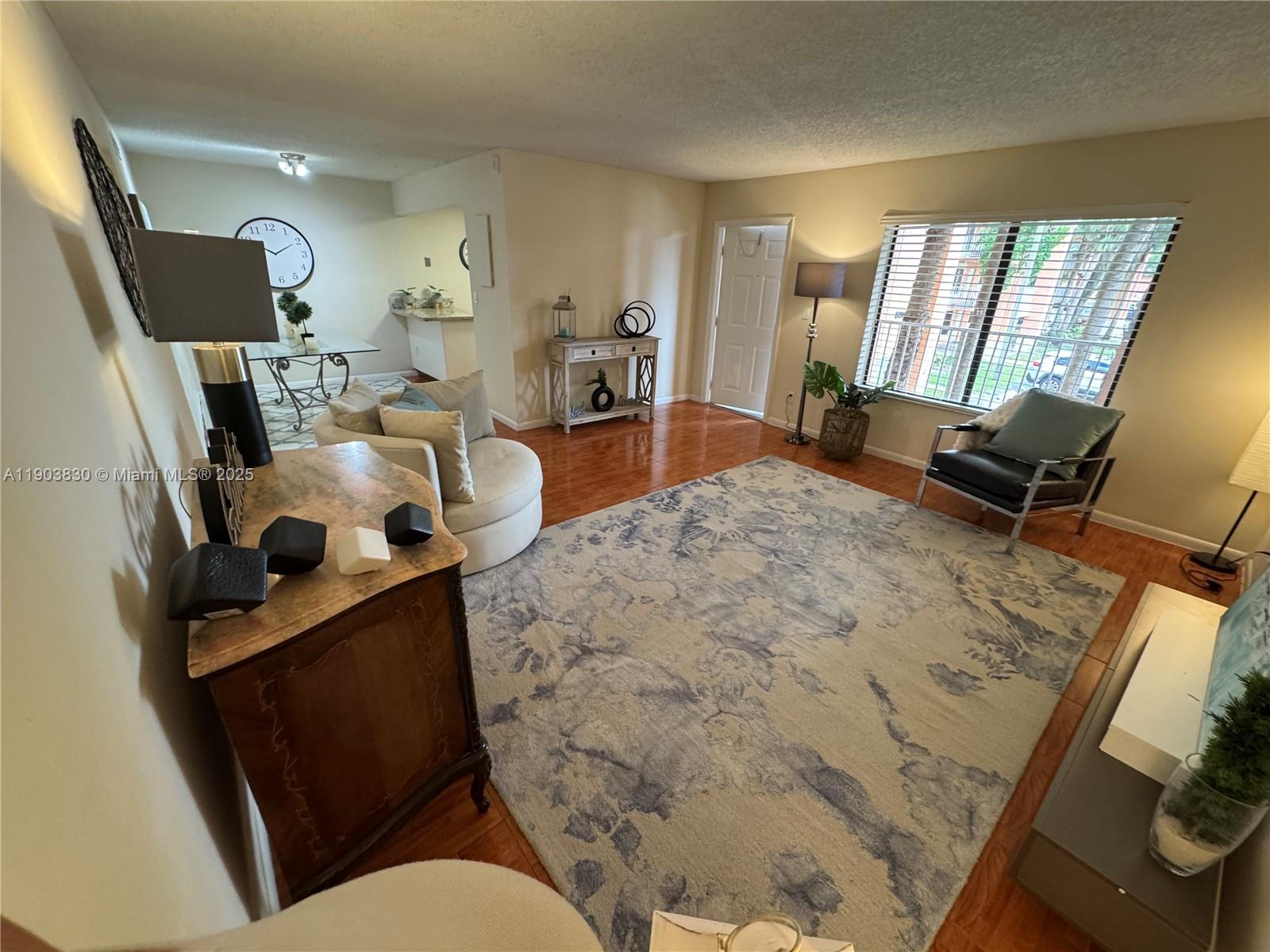 6900 Southwest 39th Street, Unit 206J Davie, FL 33314 - Photo 2 of 34 a living room with furniture and a flat screen tv