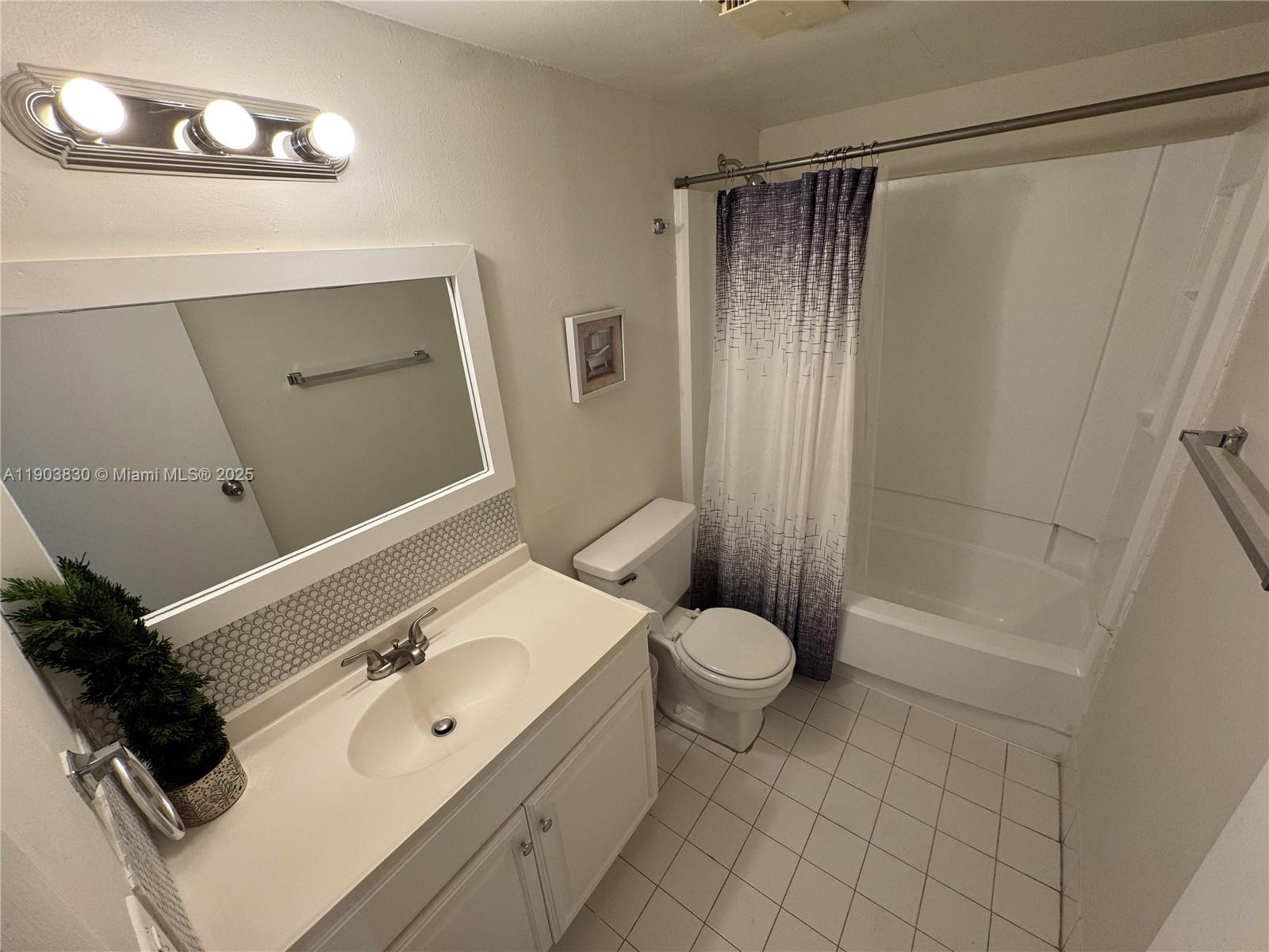 6900 Southwest 39th Street, Unit 206J Davie, FL 33314 - Photo 29 of 34 a bathroom with a sink a toilet and shower