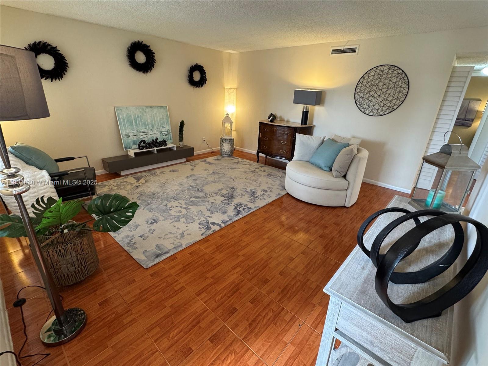 6900 Southwest 39th Street, Unit 206J Davie, FL 33314 - Photo 5 of 34 a living room with furniture and a wooden floor
