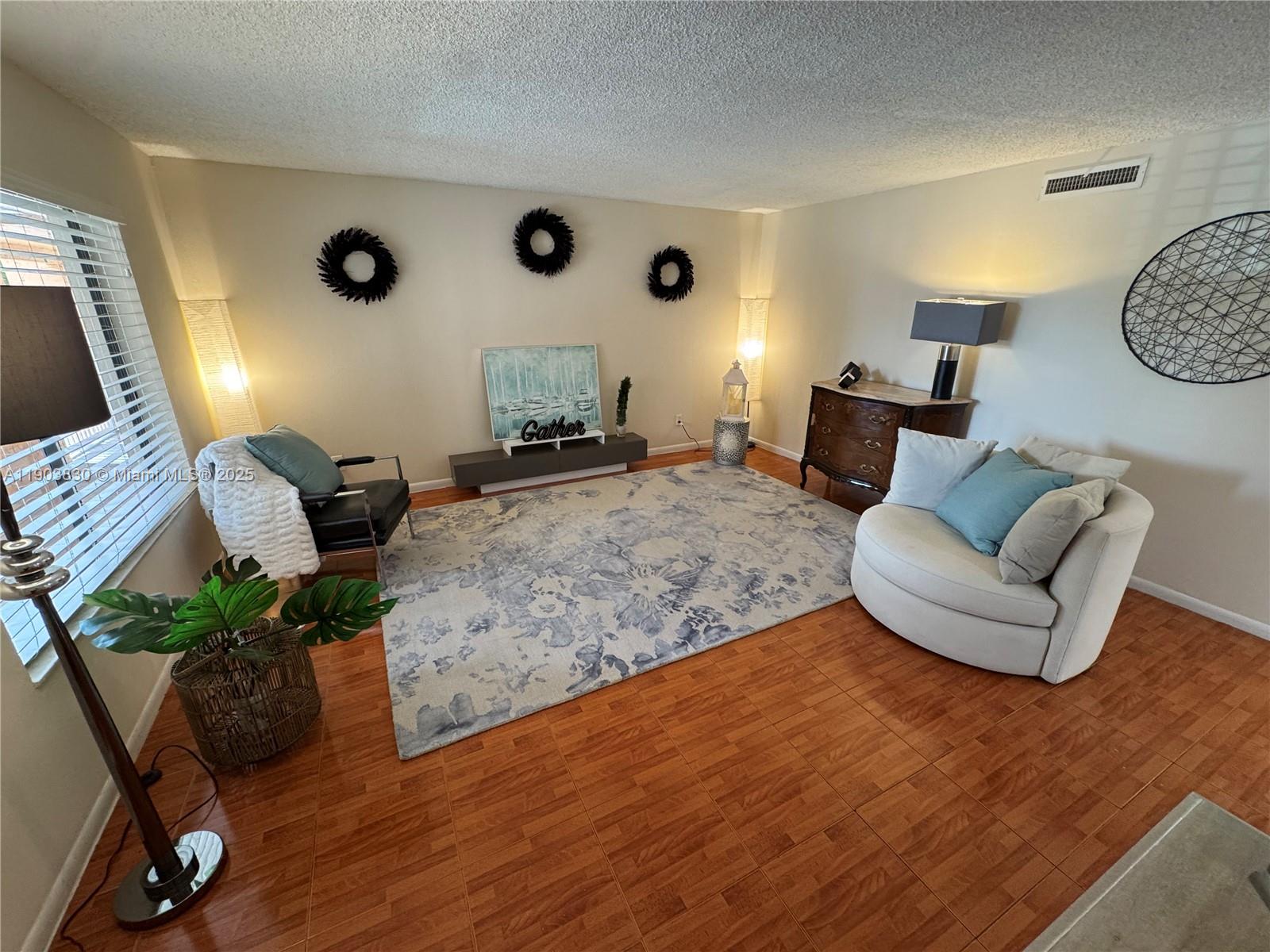 6900 Southwest 39th Street, Unit 206J Davie, FL 33314 - Photo 7 of 34 a living room with furniture and wooden floor