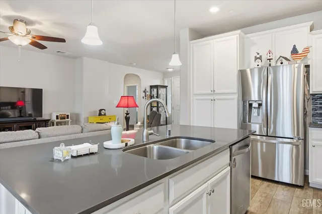 a kitchen with a refrigerator and a sink