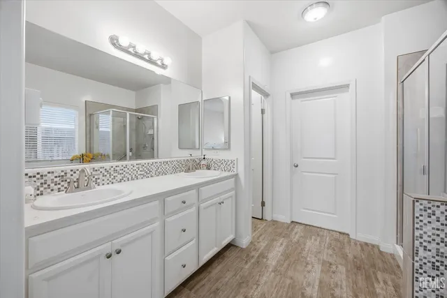 a bathroom with a granite countertop sink mirror and