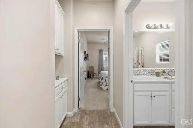 a en suite bathroom with a sink a mirror and a shower