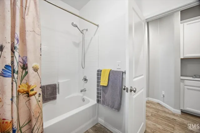 a bathroom with a tub and a shower