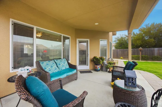 a building outdoor space with patio furniture and garden