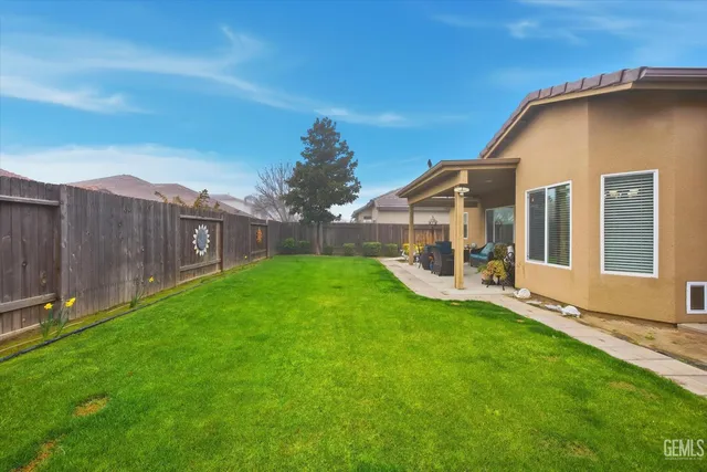 a view of a house with a yard and sitting area