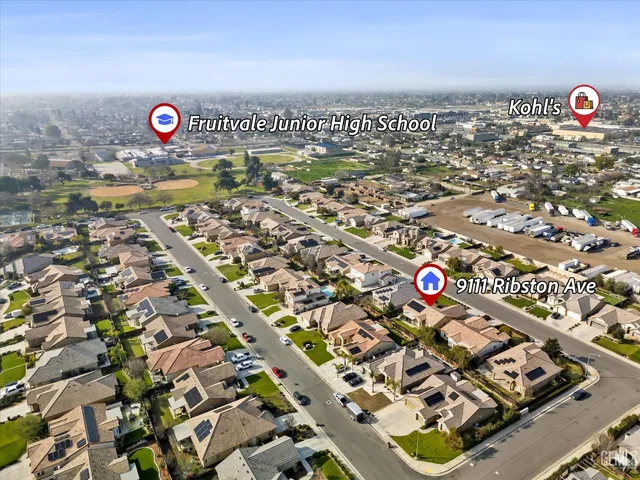 an aerial view of a house with a big yard