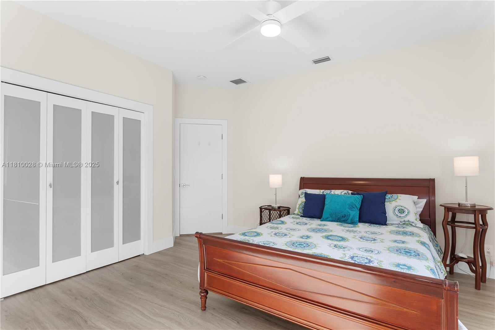 146 Dockside Circle Weston, FL 33327 - Photo 18 of 34 a bedroom with a bed and wooden floor