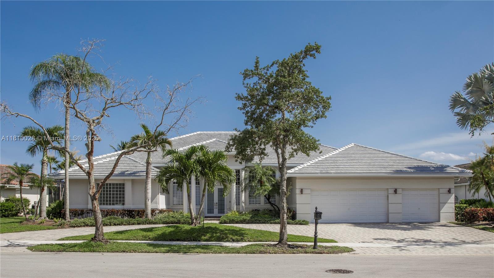 146 Dockside Circle Weston, FL 33327 - Photo 28 of 34 a front view of a house with a yard and garage