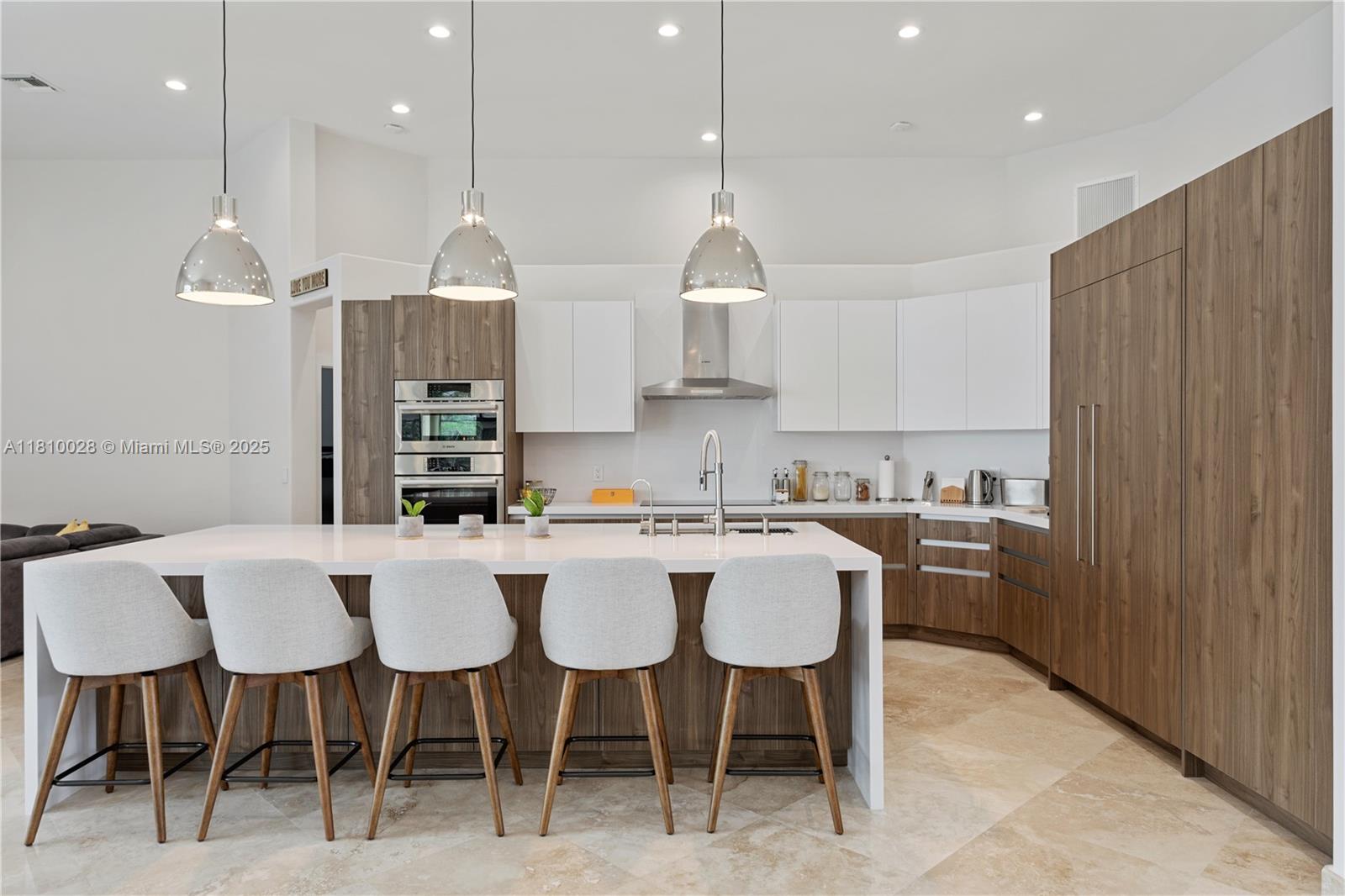 146 Dockside Circle Weston, FL 33327 - Photo 3 of 34 a kitchen with a dining table chairs and wooden cabinets