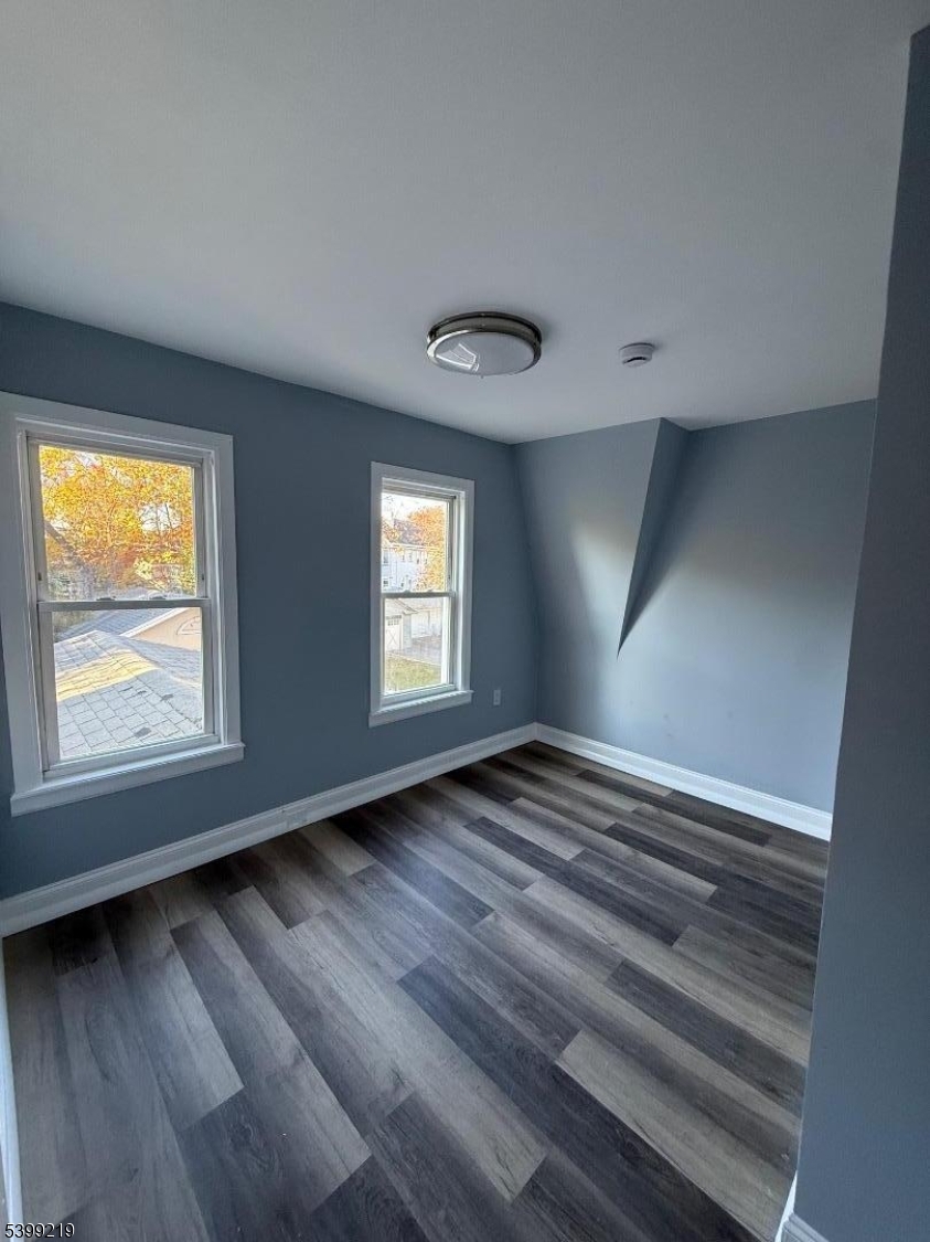 704 Park Avenue Elizabeth, NJ 07208 - Photo 12 of 15 a view of an empty room with wooden floor and a window
