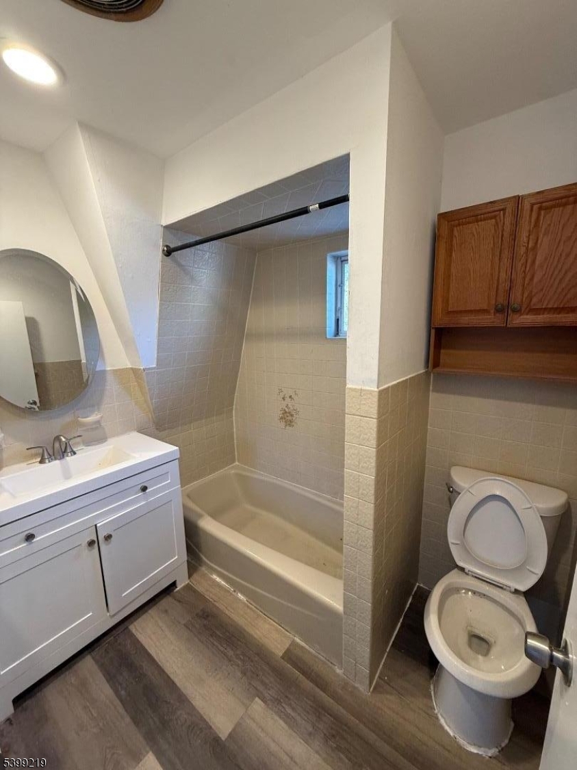 704 Park Avenue Elizabeth, NJ 07208 - Photo 15 of 15 a bathroom with a granite countertop toilet sink and mirror