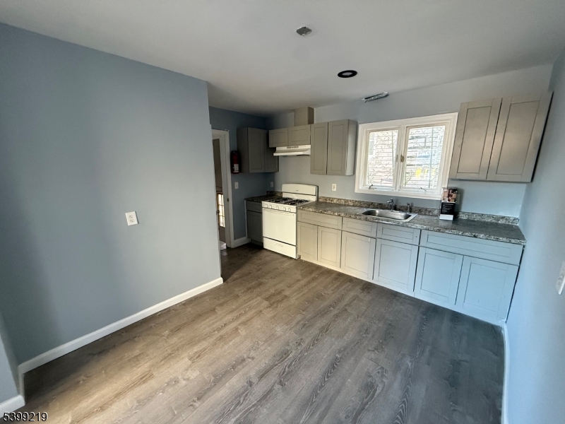 704 Park Avenue Elizabeth, NJ 07208 - Photo 7 of 15 a kitchen with stainless steel appliances granite countertop a stove a sink dishwasher and a refrigerator