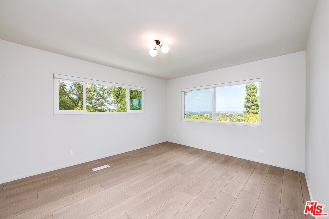 3643 Ballina Canyon Road Encino, CA 91436 - Photo 25 of 47 an empty room with windows