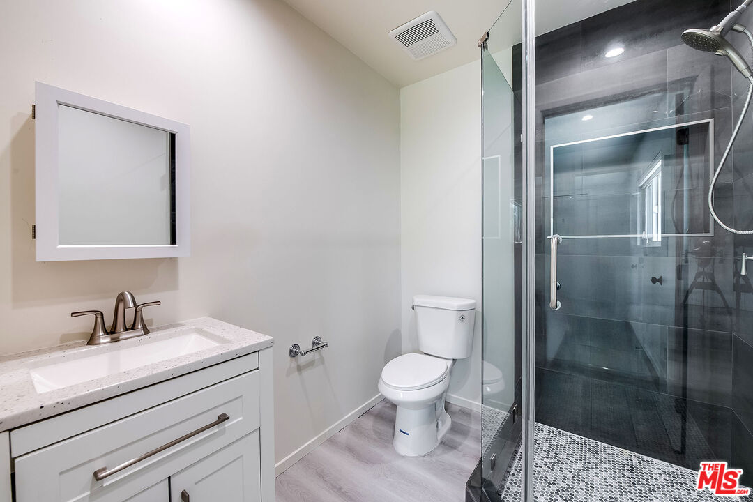 3643 Ballina Canyon Road Encino, CA 91436 - Photo 29 of 47 a bathroom with a sink toilet and shower