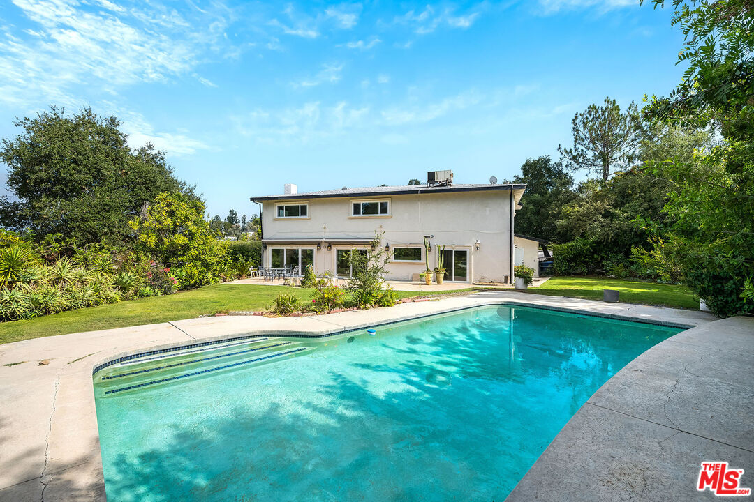 3643 Ballina Canyon Road Encino, CA 91436 - Photo 45 of 47 a view of a house with pool and a yard