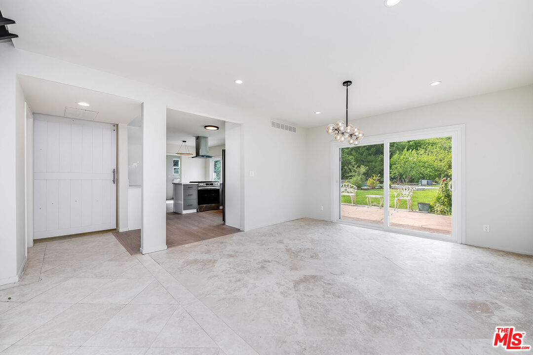 3643 Ballina Canyon Road Encino, CA 91436 - Photo 6 of 47 a view of an empty room with a window and kitchen view