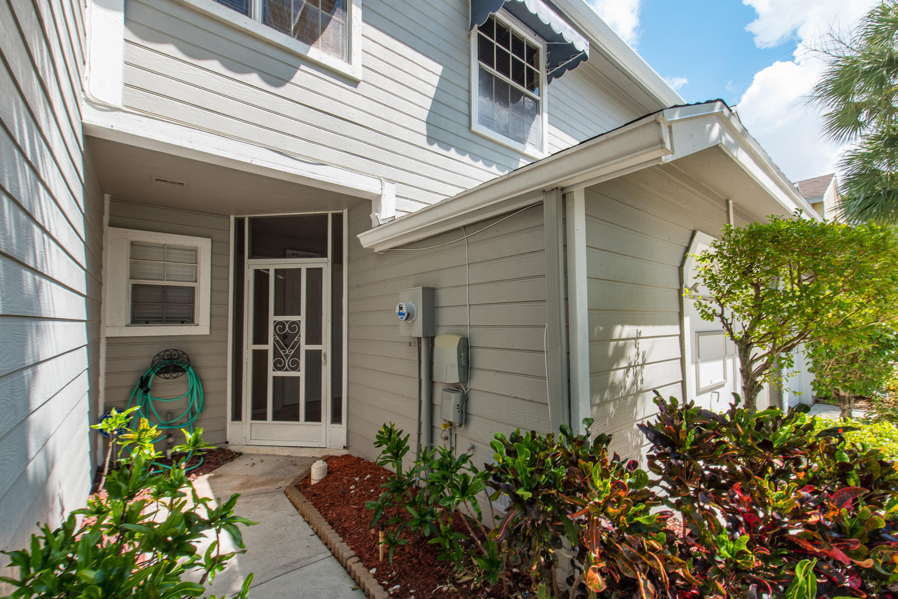 5116 Pointe Emerald Lane, Unit 5116 Boca Raton, FL 33486 - Photo 13 of 23 a front view of a house with a garden