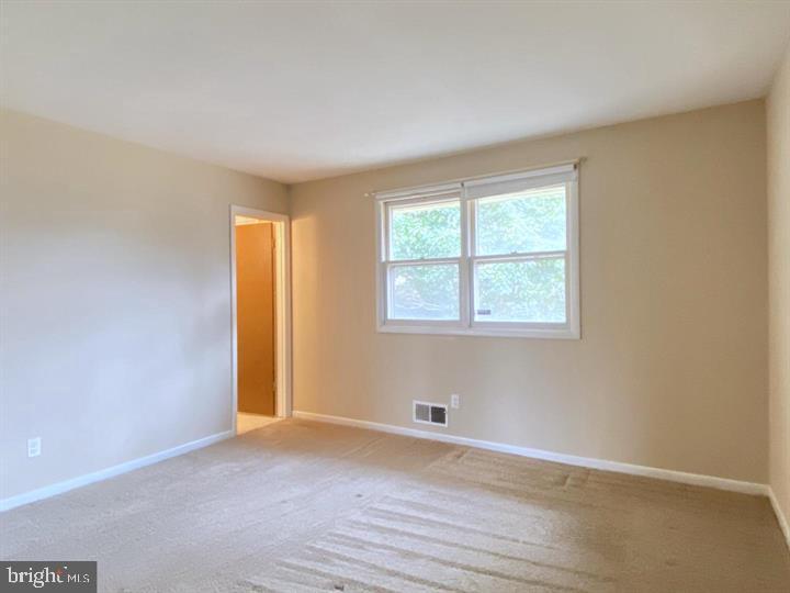 3300 Upton Road Baltimore, MD 21234 - Photo 19 of 40 an empty room with wooden floor and windows