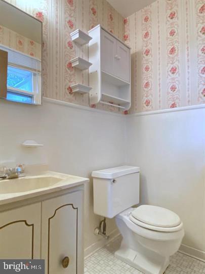 3300 Upton Road Baltimore, MD 21234 - Photo 20 of 40 a bathroom with a sink a toilet and a mirror