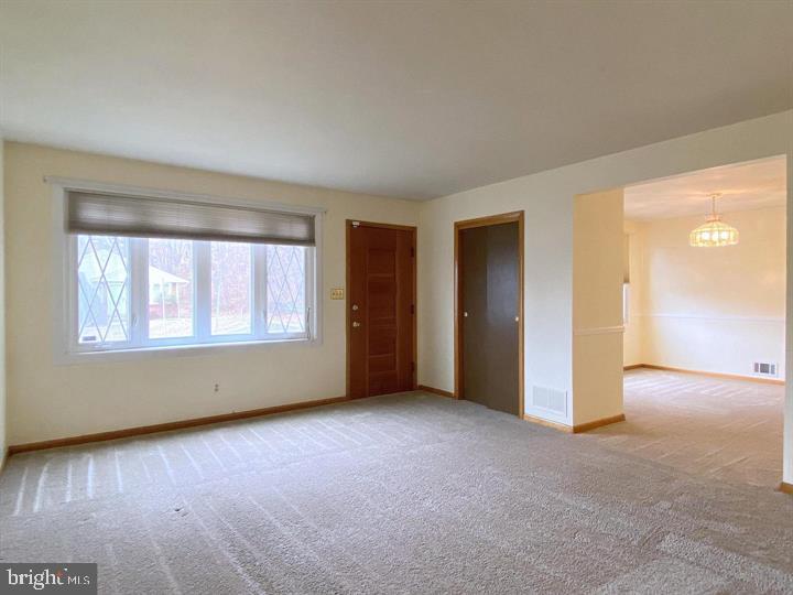 3300 Upton Road Baltimore, MD 21234 - Photo 5 of 40 a view of an empty room with wooden floor and a window
