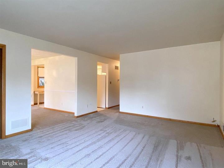 3300 Upton Road Baltimore, MD 21234 - Photo 6 of 40 an empty room with wooden floor & windows