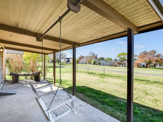 a view of a living room and floor to ceiling windows with an umbrella