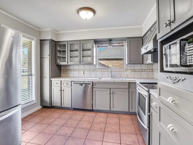 a kitchen with a sink stove and cabinets