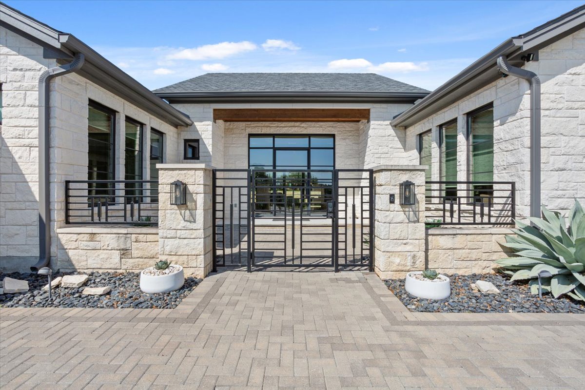 309 Highland Spring Lane Georgetown, TX 78633 - Photo 2 of 40 The long & winding driveway is made of paver bricks. To the left of this courtyard are the 3 side-entry garages.