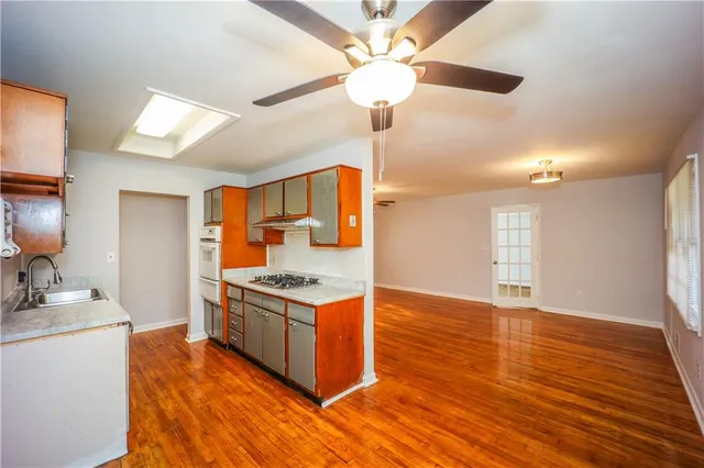 a kitchen view with wooden floor