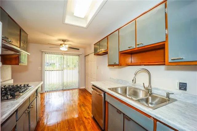 a kitchen with sink a stove and cabinets